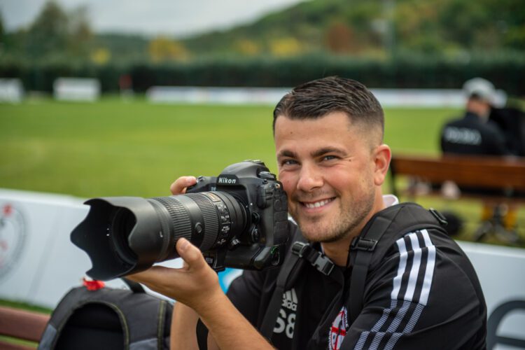 Photographer Smiling Taking Pictures At Football Match